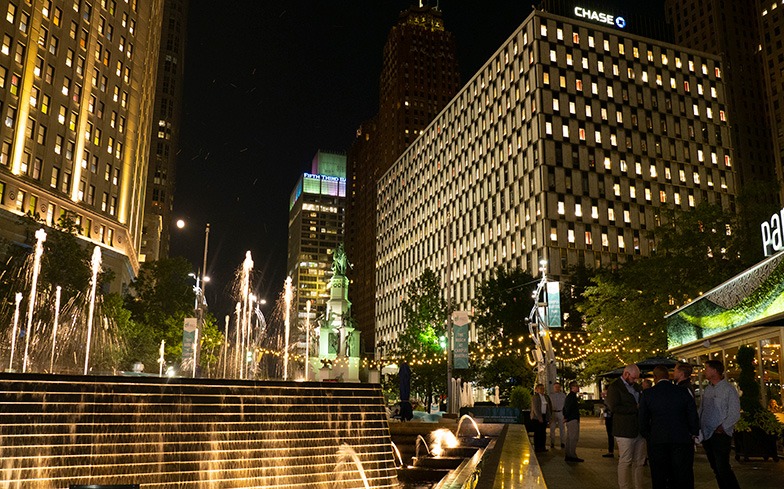 People congregating around fountain at night in Detroit Downtown