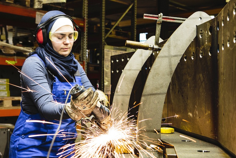 Woman welding in a manufacturing workshop