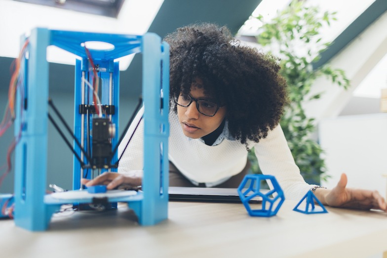 Woman programming a 3D printer