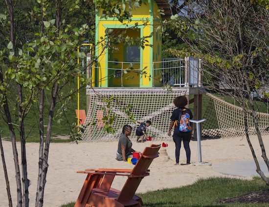 Family playing on a playground at Riverwalk Park