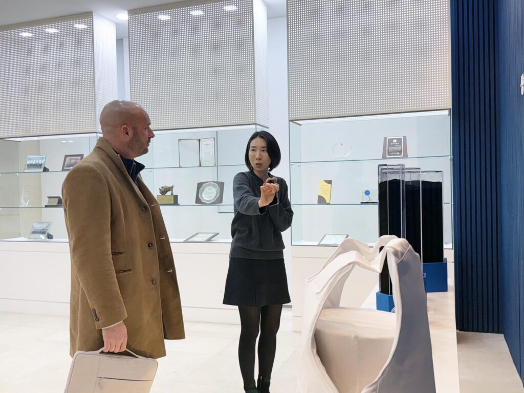 A Man and a woman talking in front of a product on display