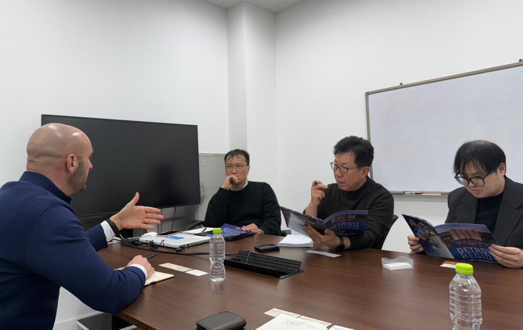 Four men talking at a table