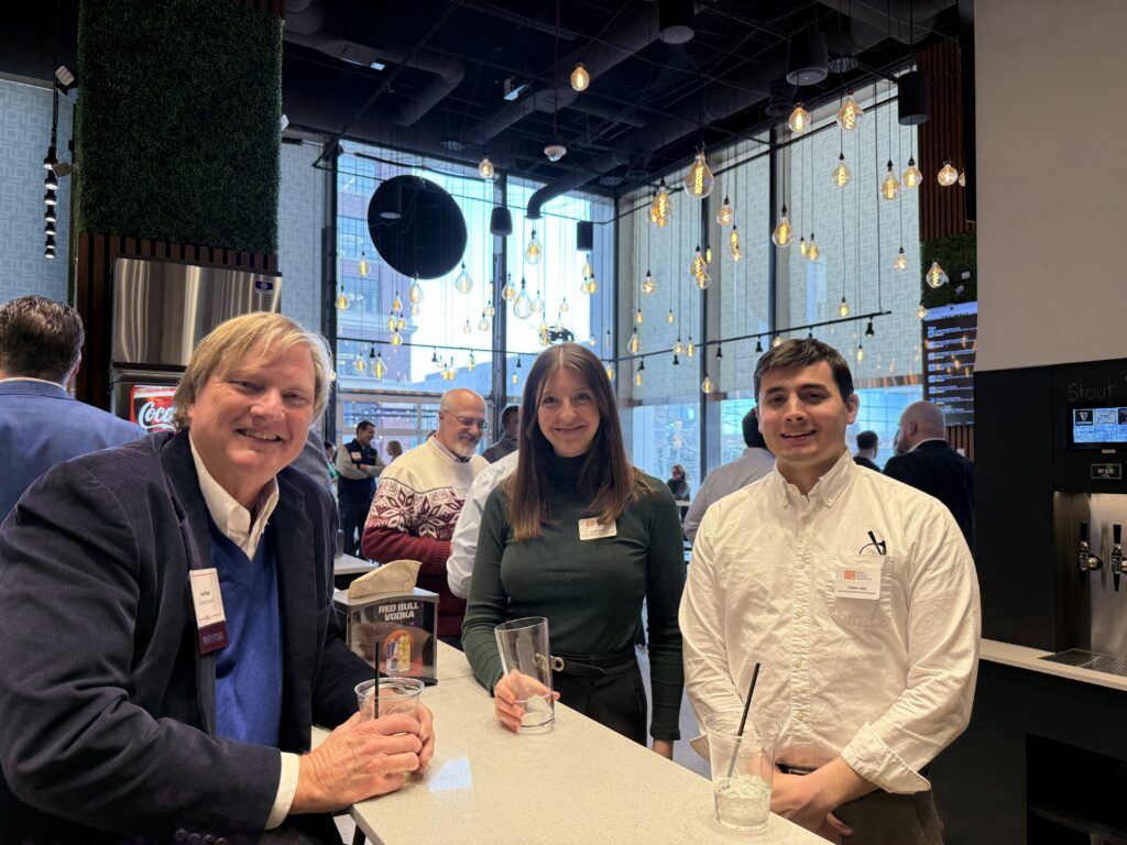 Two men and a woman posing for a photo together