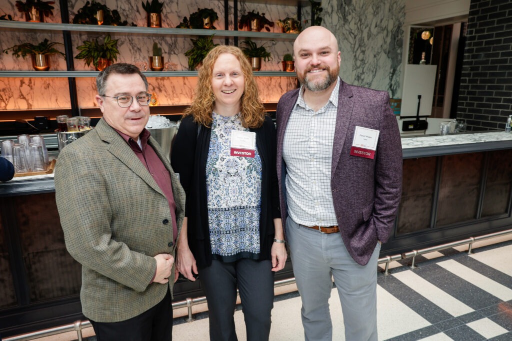 Three people standing side by side