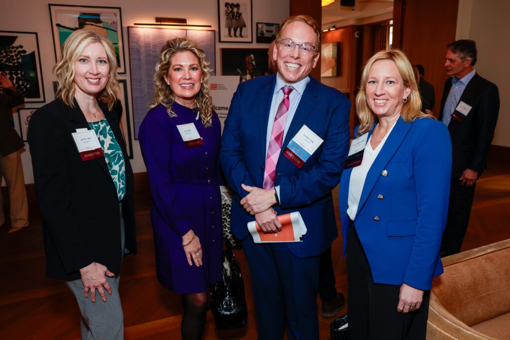 Group of four people standing together