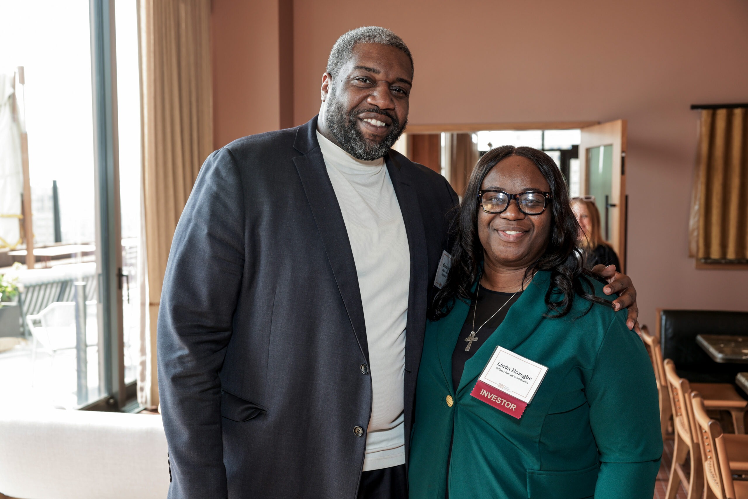 Two people standing together at a networking event