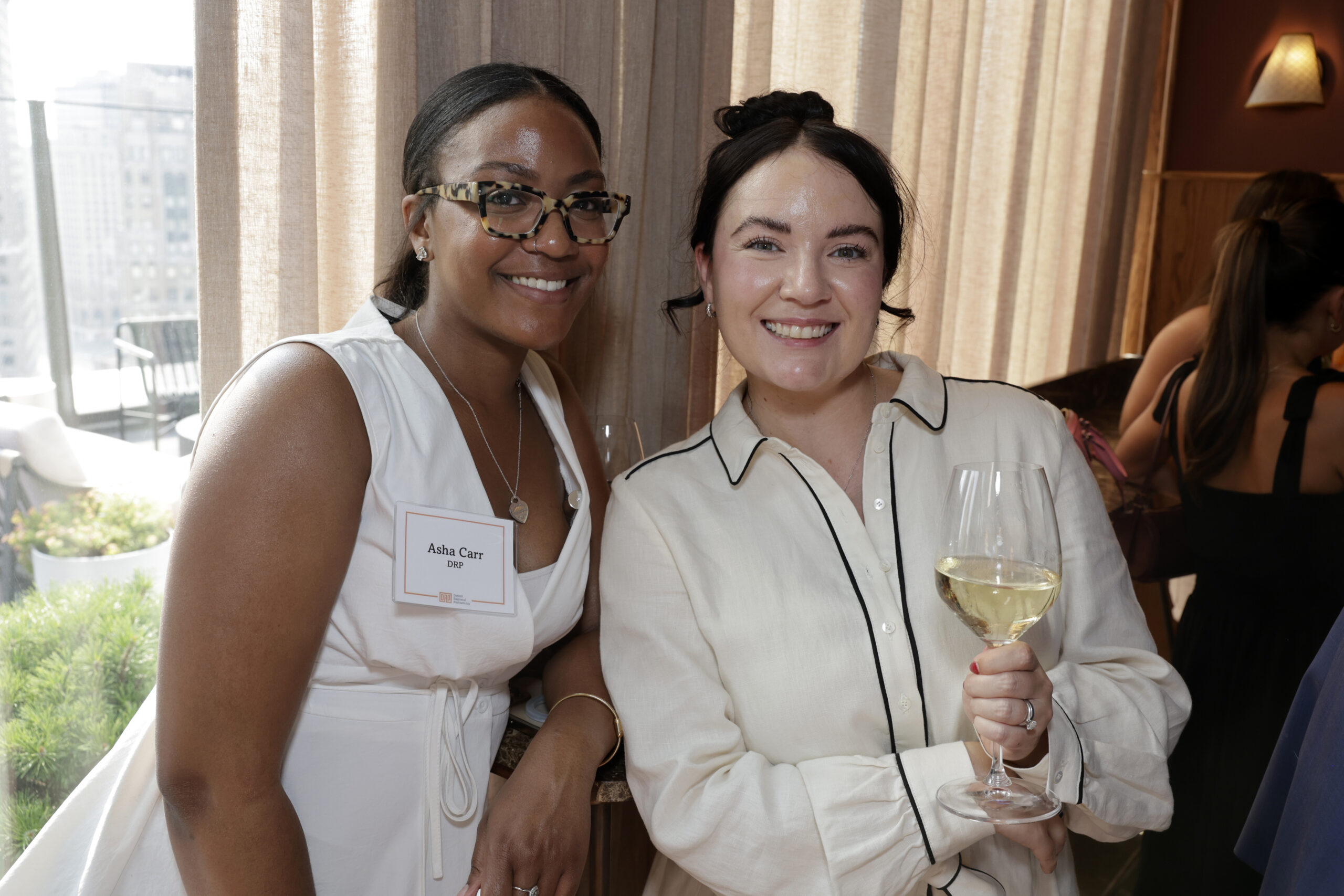 Two people standing together at a networking event