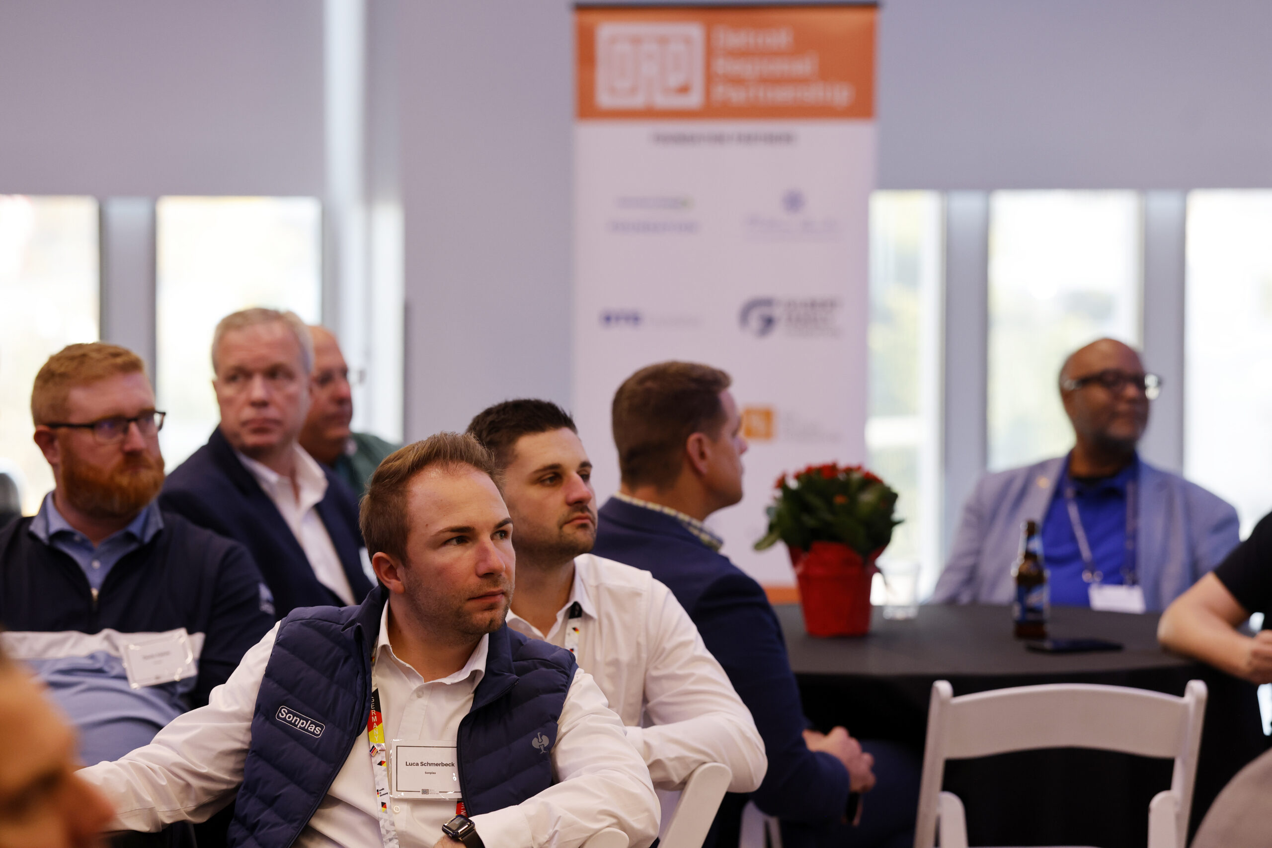 Group of people sitting and listening to a speaker